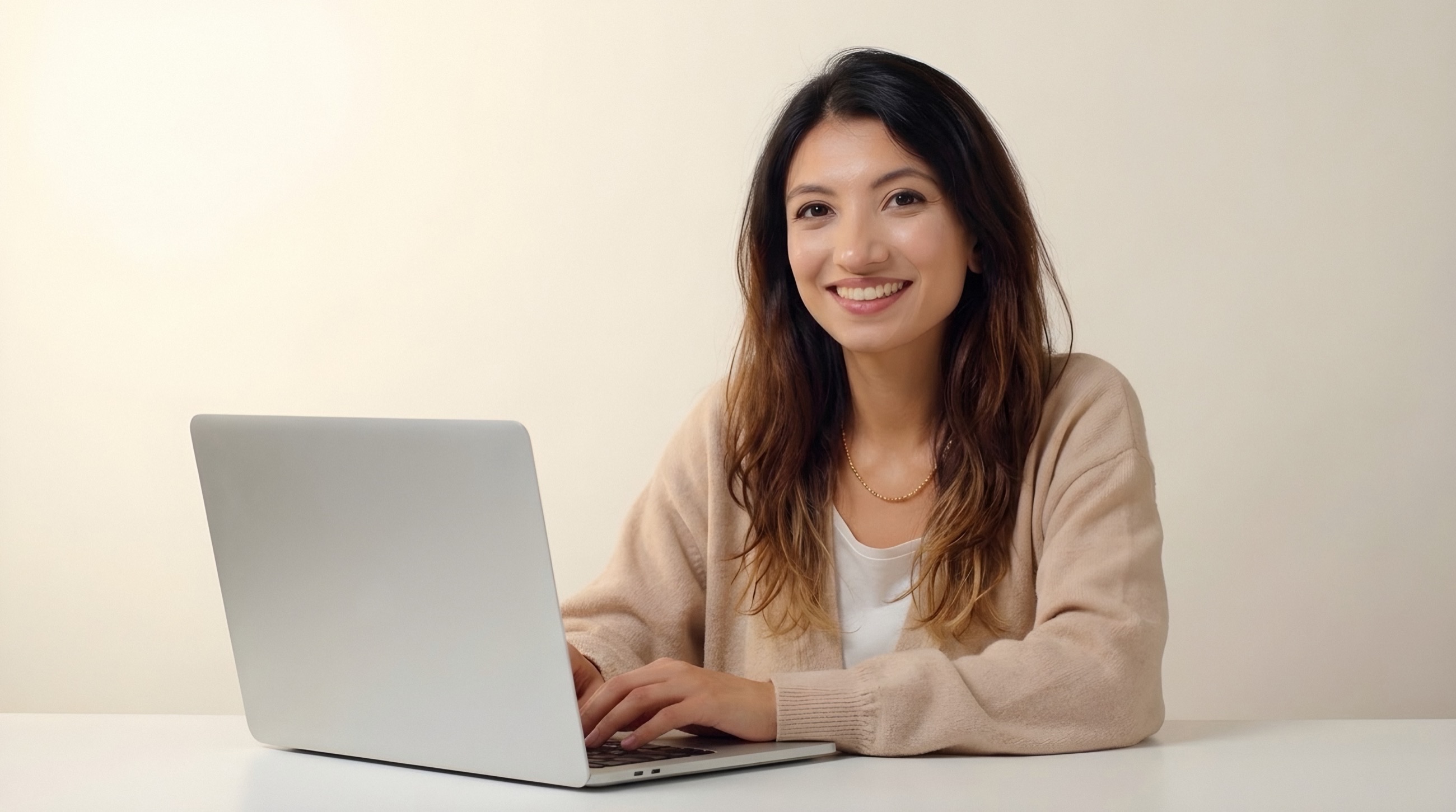 Me at my desk, smiling, my laptop open beside me